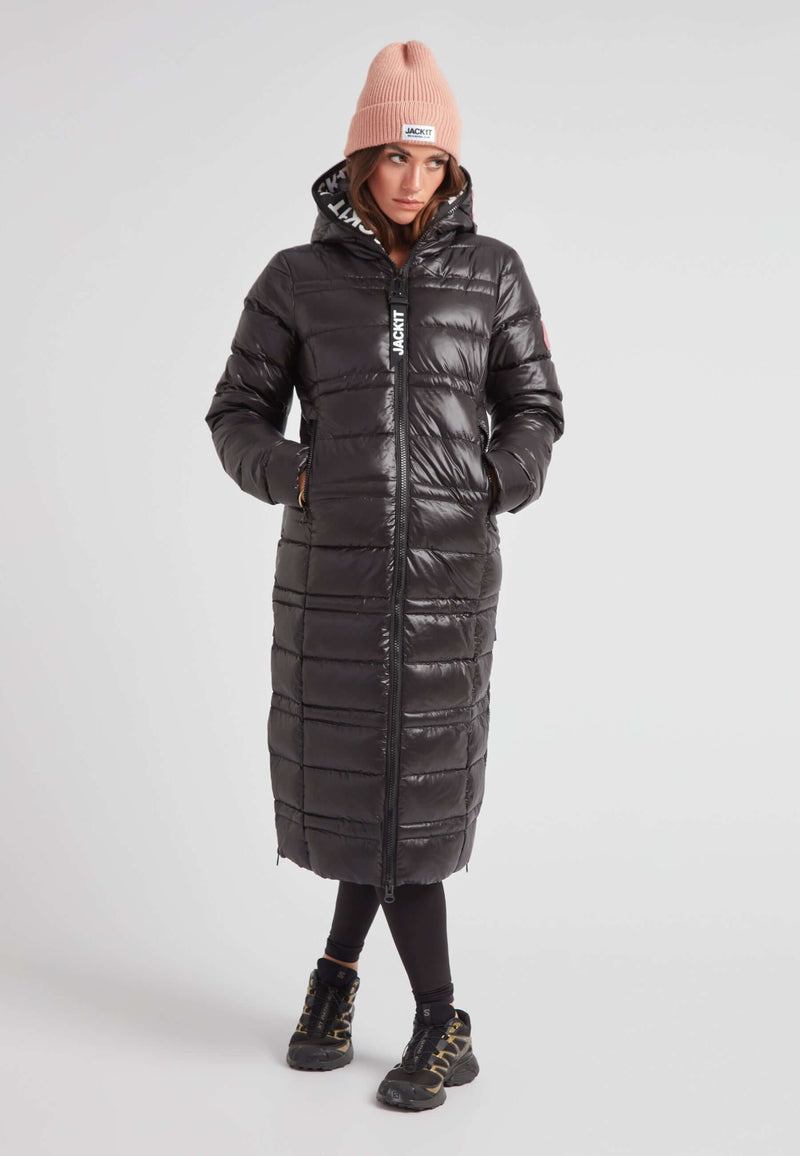 R4D Tramline Extra Long Down Coat Lux Black worn by a model, featuring a fixed hood and water-repellent shell.