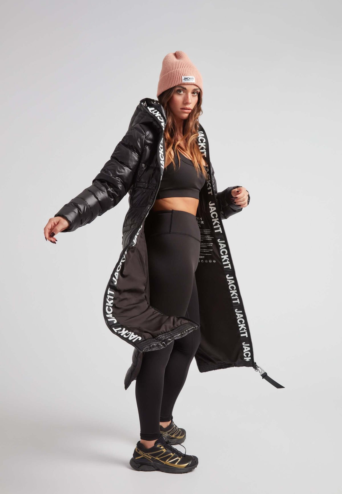 Model wearing the R4D Tramline Extra Long Down Coat Lux Black with stylish activewear.