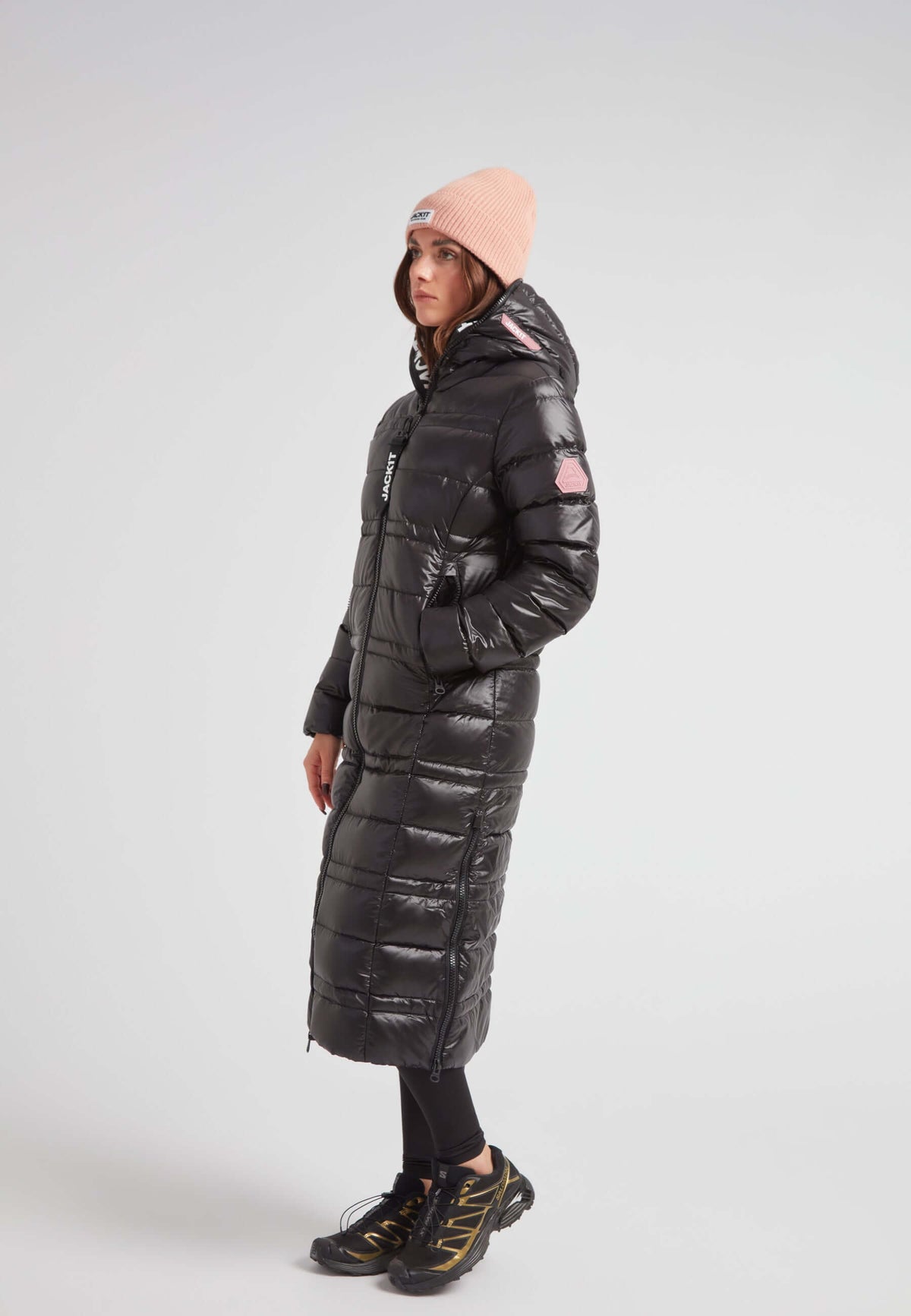 R4D Tramline Extra Long Down Coat Lux Black worn by a model, featuring a fixed hood and side-zip vents.