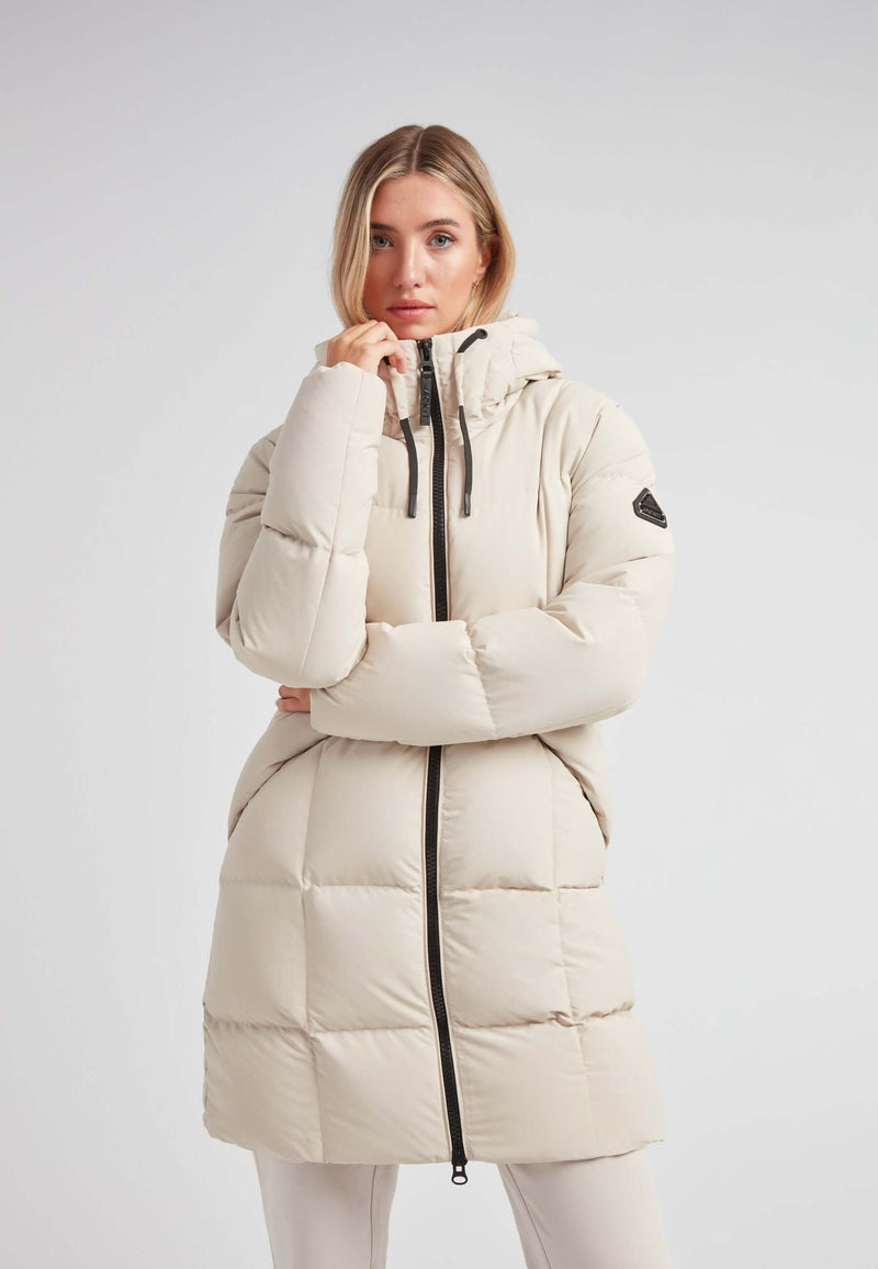 Model wearing the Black Star Puffer Down Coat Stone in a light color, showcasing its stylish design and functionality.