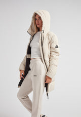 Model wearing the Black Star Puffer Down Coat Stone, featuring a hood and casual winter attire.