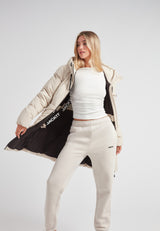 Model wearing the Black Star Puffer Down Coat Stone, showcasing its adjustable waist and minimalist design.