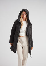 Black Star Puffer Down Coat Black worn by a model, showcasing its stylish design and functional elements.