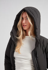 Model wearing the Black Star Puffer Down Coat Black with a hood, showcasing its stylish design and warmth.