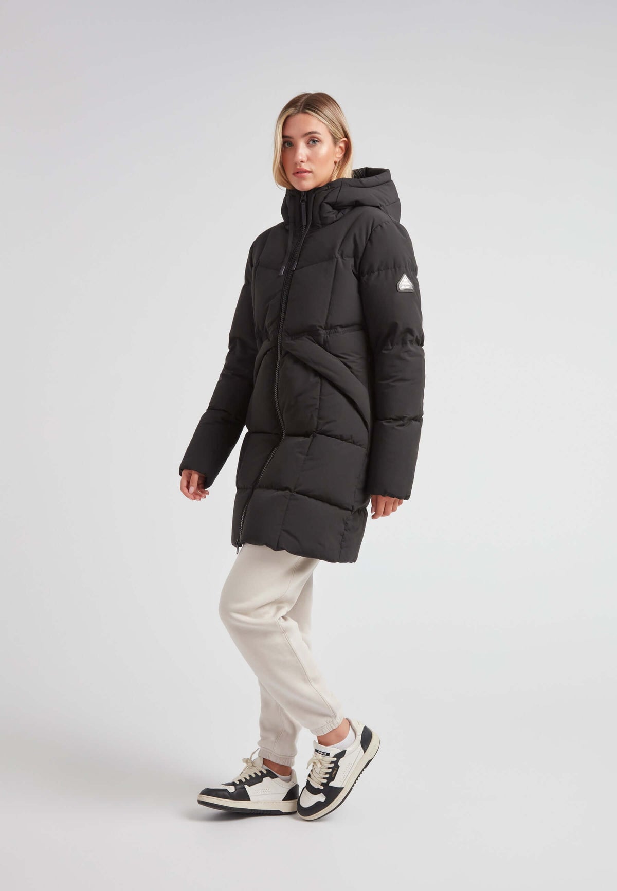 Model wearing the Black Star Puffer Down Coat Black, showcasing its stylish design and functionality in winter styling.