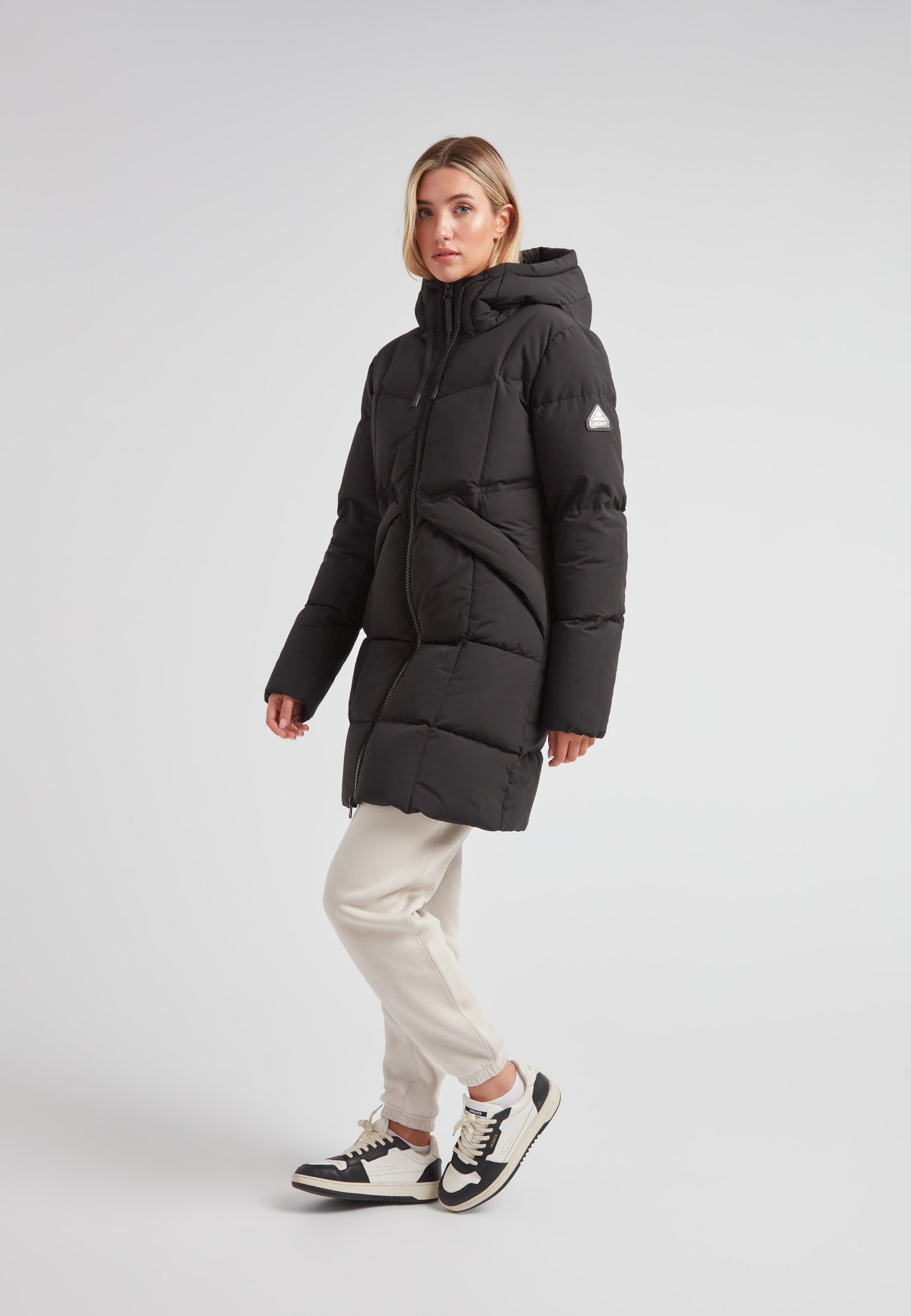 Model wearing the Black Star Puffer Down Coat Black, showcasing its stylish design and functionality in winter styling.