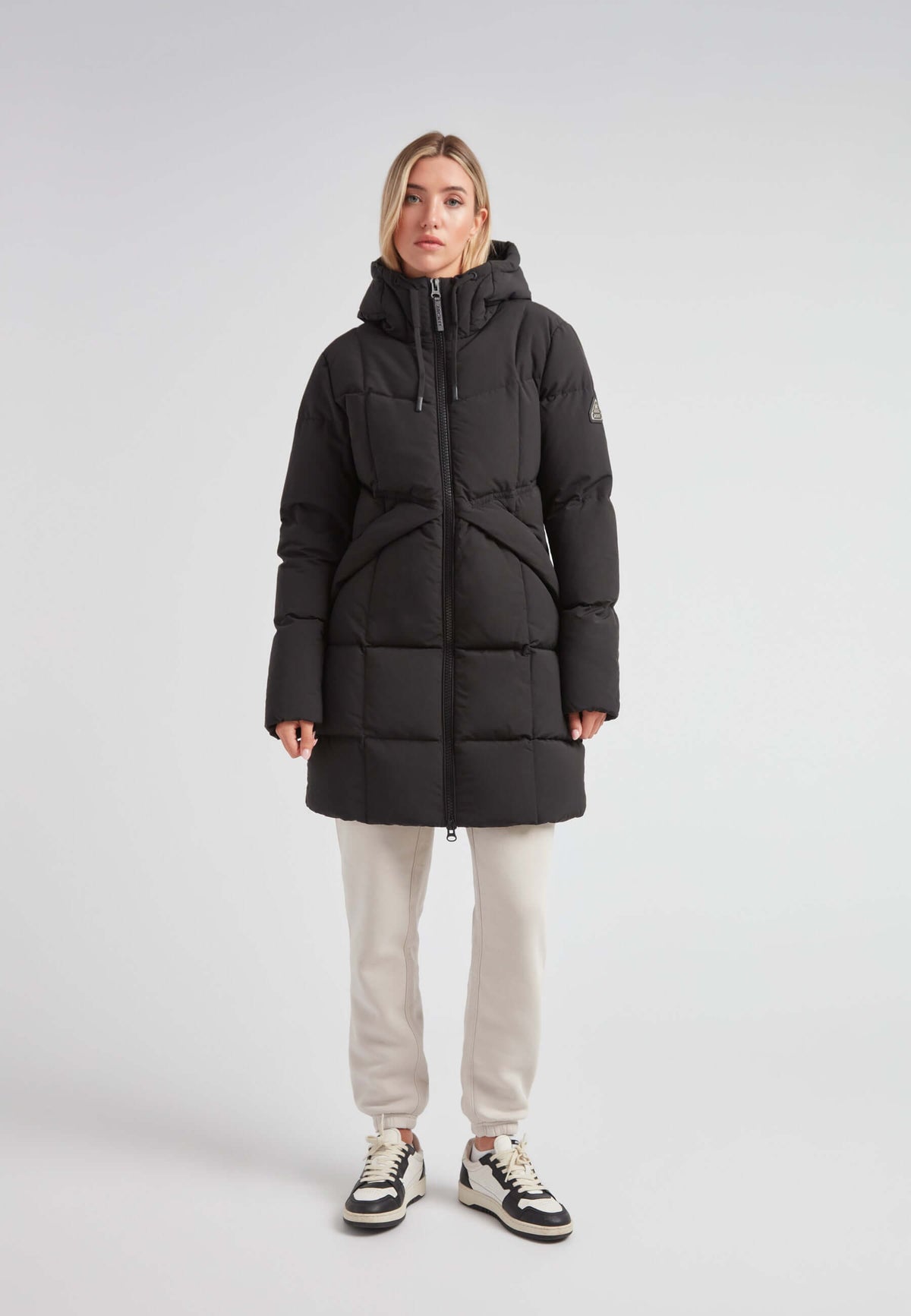 Model wearing a Black Star Puffer Down Coat Black, showcasing its stylish and functional design.