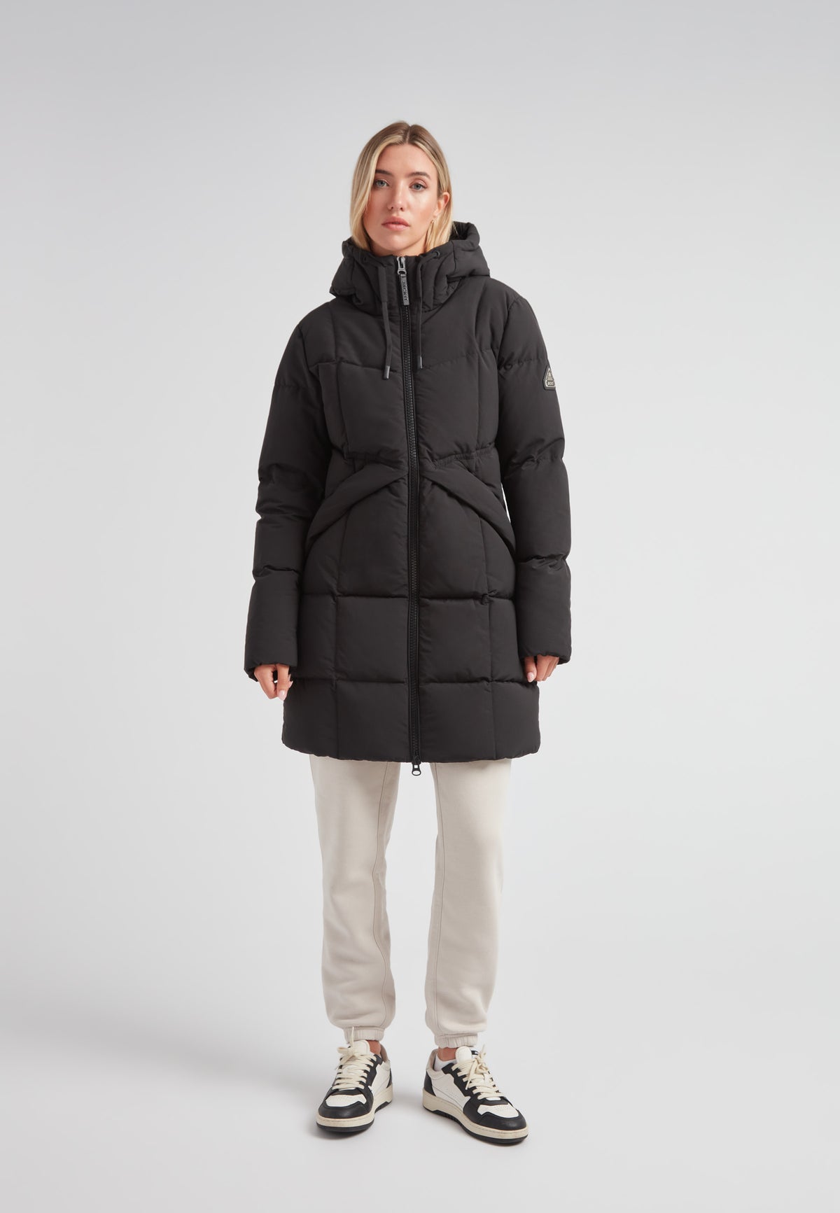 Model wearing a Black Star Puffer Down Coat Black, showcasing its stylish and functional design.
