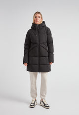 Model wearing a Black Star Puffer Down Coat Black, showcasing its stylish and functional design.