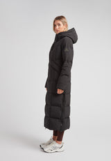 Black Star Extra Long Down Coat Matt Black worn by a model, showcasing its ankle-grazing length and minimalist design.