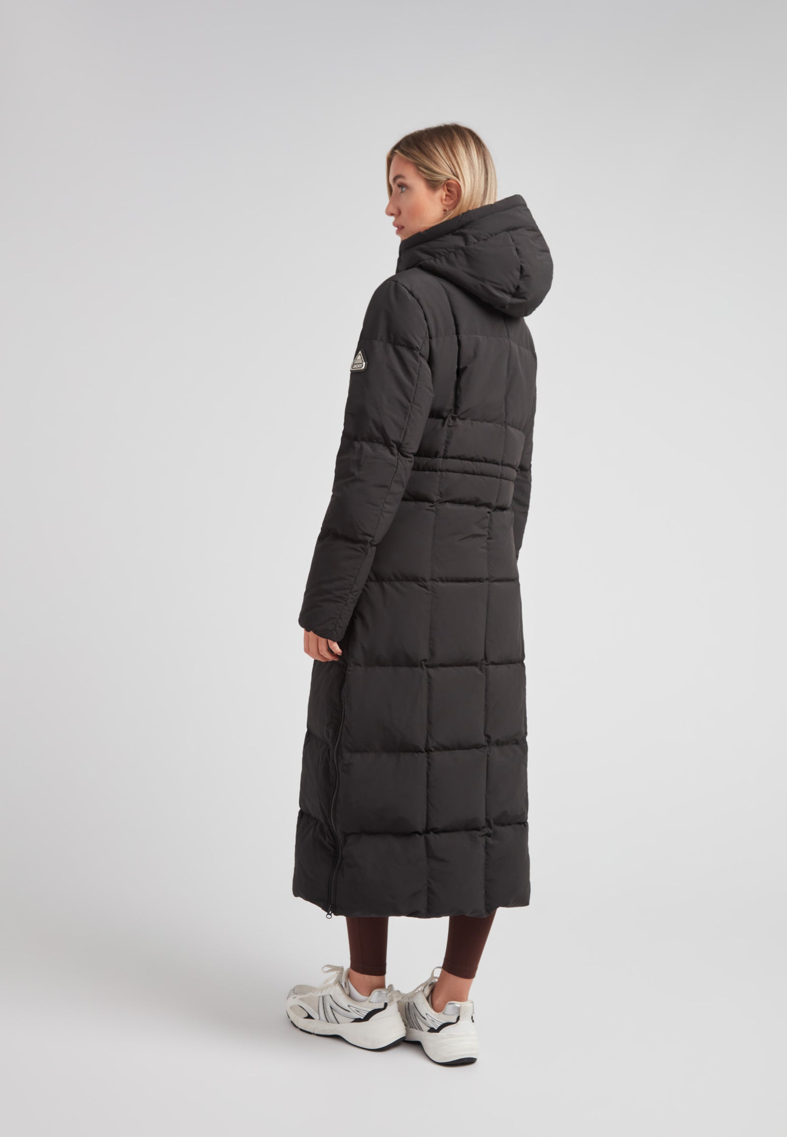 Black Star Extra Long Down Coat Matt Black on model, showcasing the back view with an adjustable hood.