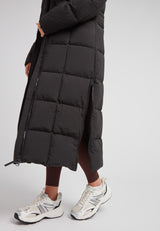 Black Star Extra Long Down Coat Matt Black showcased with sleek design and stylish silver sneakers.
