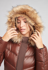 Model wearing the Diamond Belted Extra Long Down Coat Mid Brown Natural with faux fur hood.