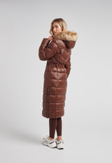 Model wearing the Diamond Belted Extra Long Down Coat Mid Brown Natural from the back, showcasing its luxurious design and faux fur hood.