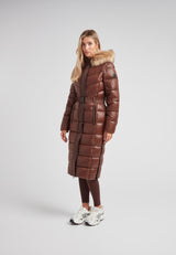 Diamond Belted Extra Long Down Coat Mid Brown Natural worn by a model, featuring a faux fur hood and glossy finish.