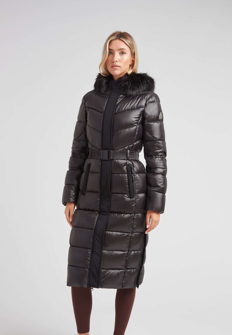 Women's puffer coat with fur hood in black, featuring a belted waist and full-length silhouette.