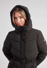 Woman wearing the Diamond Belted Down Coat Matt Black with a stylish hood, showcasing its refined winter design.