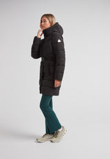 Woman wearing the Diamond Belted Down Coat Matt Black with hood and belt, paired with green leggings and sporty shoes.