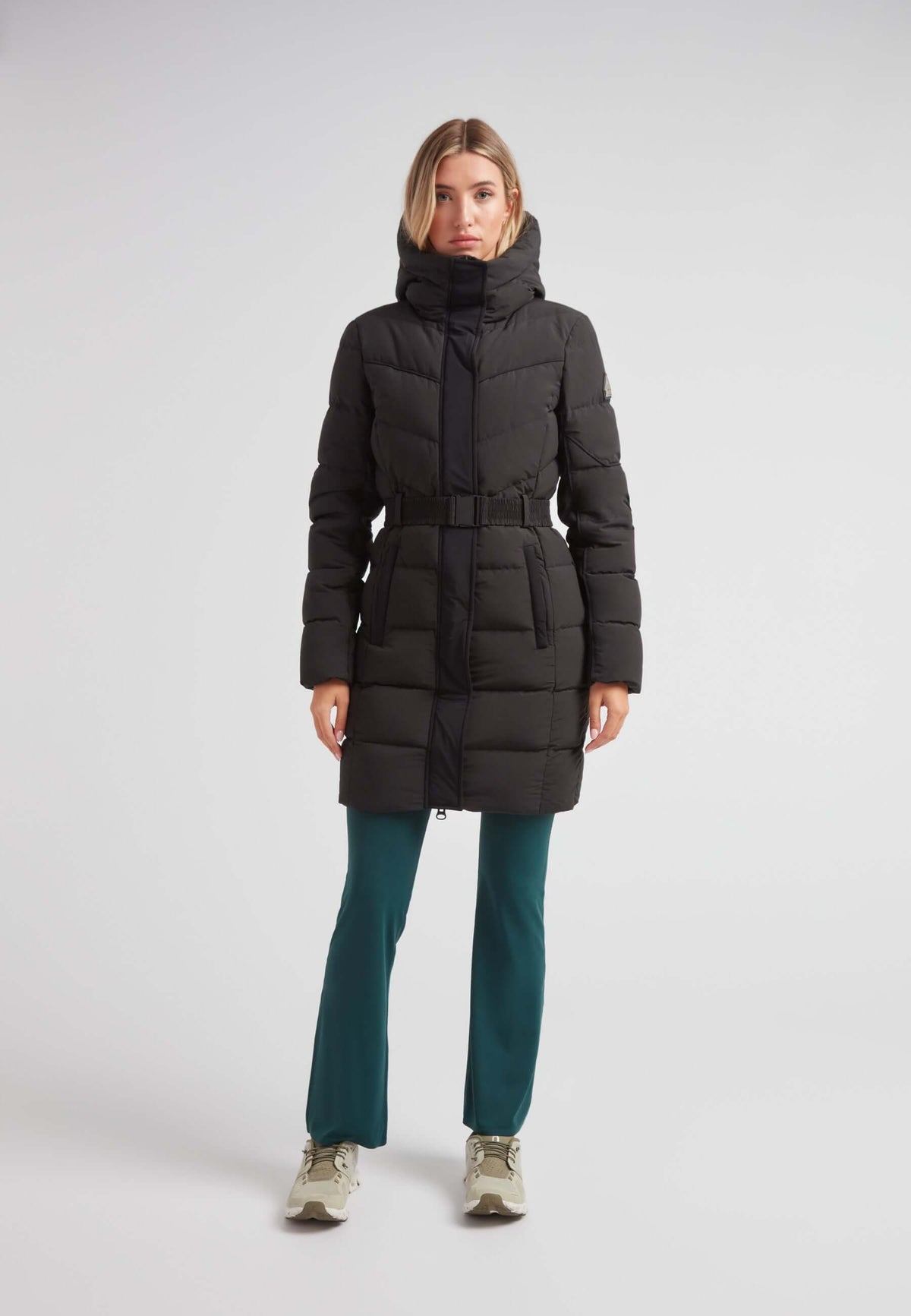Diamond Belted Down Coat Matt Black worn by a model against a neutral background, showcasing its elegant design.
