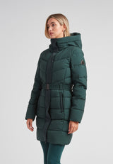 Diamond Belted Down Coat Matt Emerald worn by a woman, showcasing its sophisticated design and winter functionality.