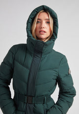 Diamond Belted Down Coat Matt Emerald worn by a woman with a hood, showcasing sophisticated winter style.