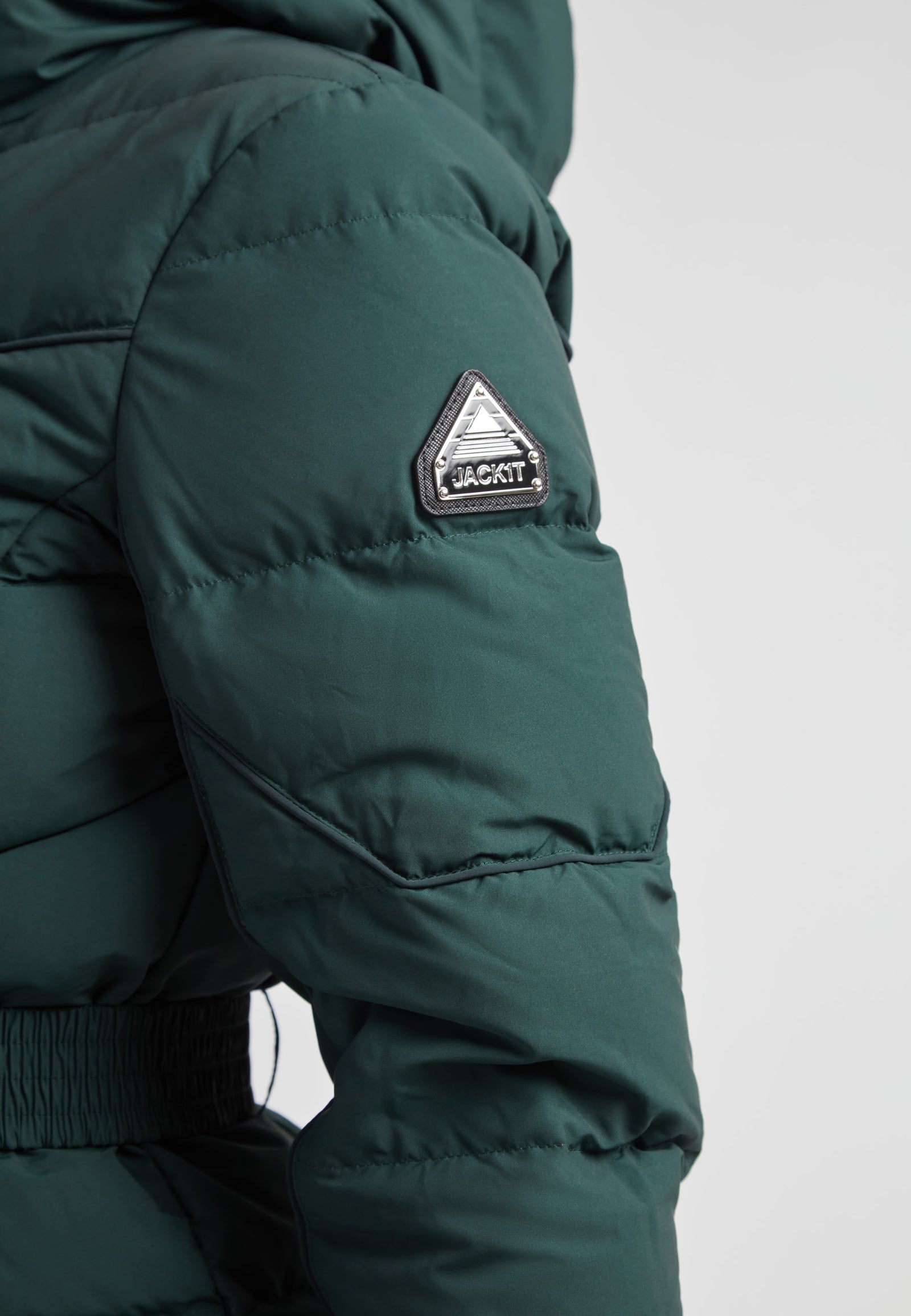 Diamond Belted Down Coat Matt Emerald close-up view showing the arm detail and logo badge.