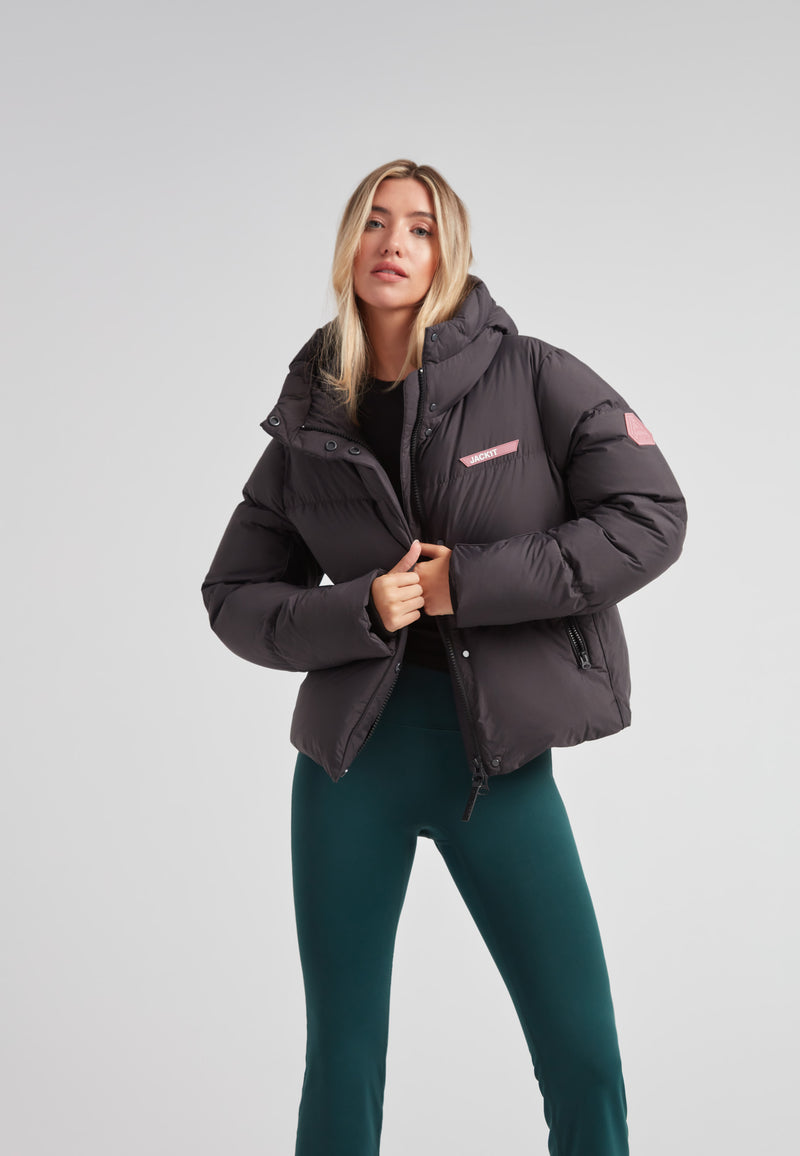 Star Shower Down Puffer Jacket Black worn by a woman, featuring a sleek design and contemporary finish.