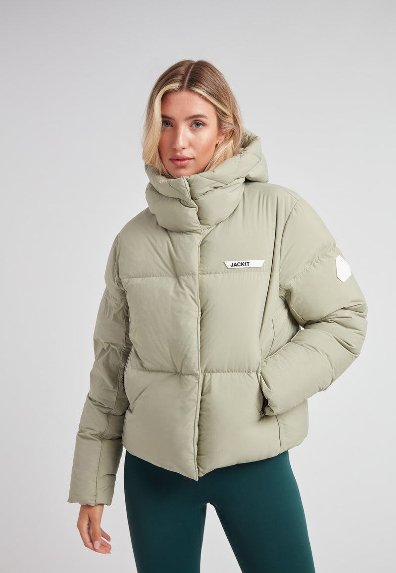 Star Shower Down Puffer Jacket Sage in soft green, featuring a cozy hood and contemporary design for winter wear.