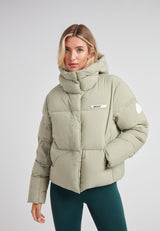 Star Shower Down Puffer Jacket Sage in soft green, featuring a cozy hood and contemporary design for winter wear.