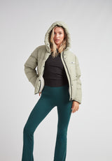 Star Shower Down Puffer Jacket Sage worn by a model in a stylish winter outfit.