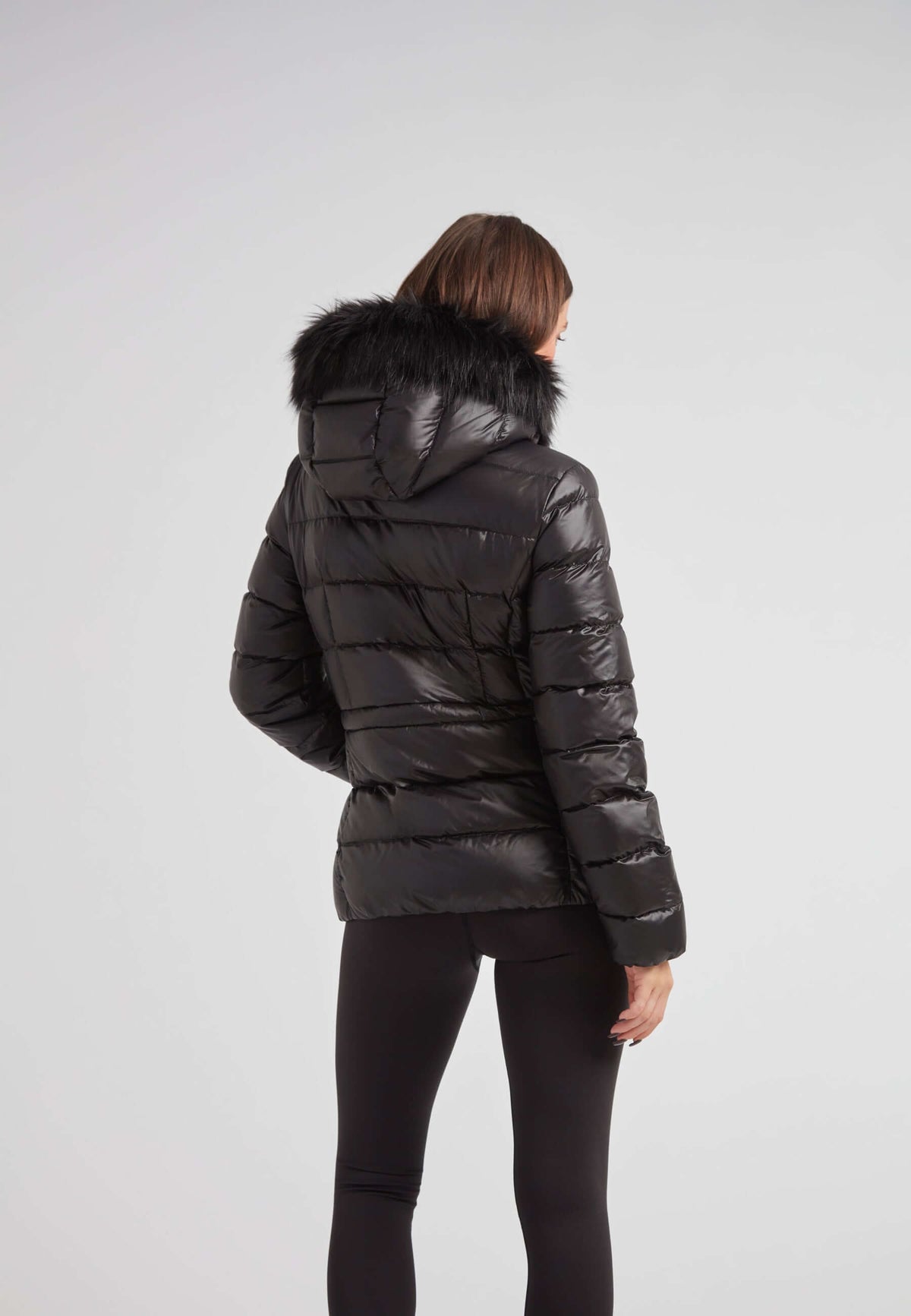 Black puffer jacket with fur hood featuring a stylish removable faux fur trim.