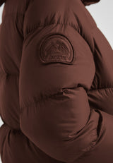 Cocoon Ultra Long Down Coat Mid Brown showcasing the textured sleeve and logo detail