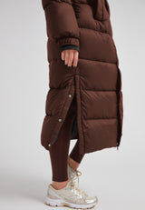Cocoon Ultra Long Down Coat Mid Brown featuring side-opening vents and a warm oversized silhouette.