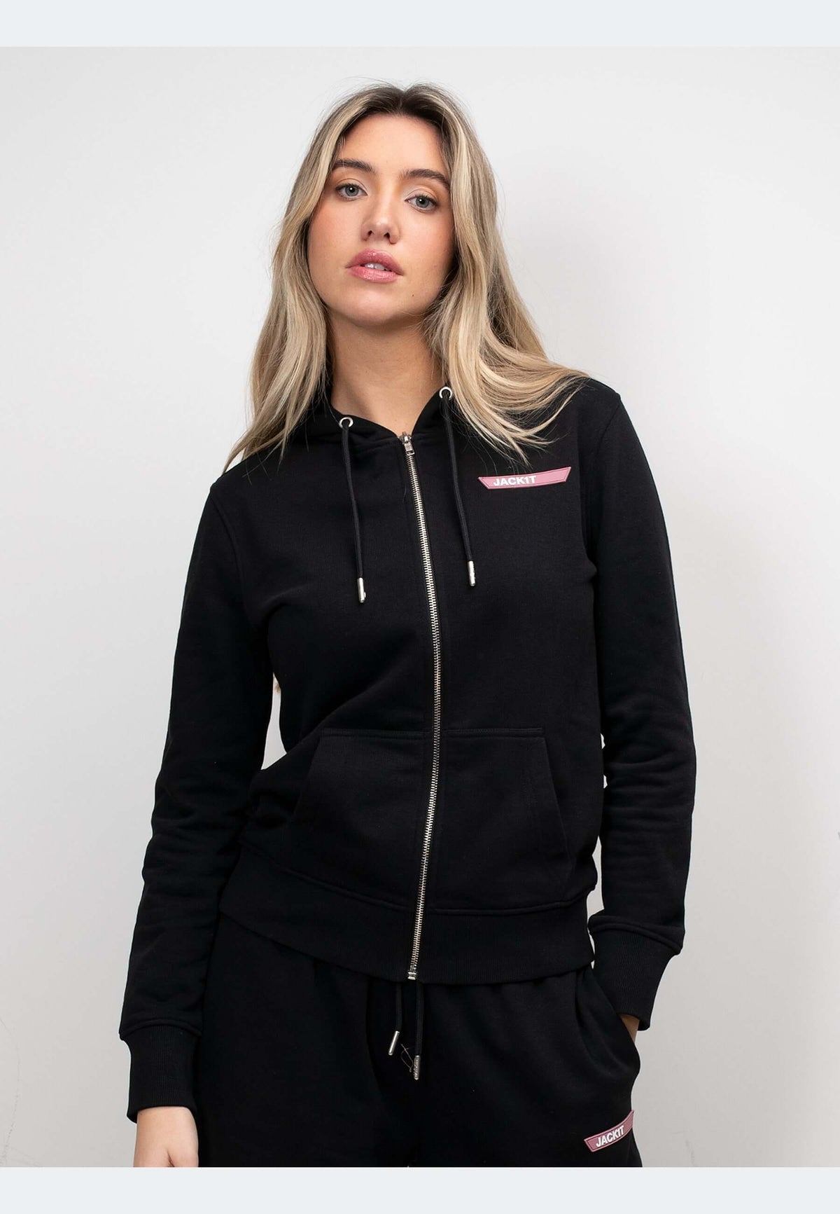 zip through black hoodie on a model, featuring full zip and brand detailing, perfect for relaxed layering.