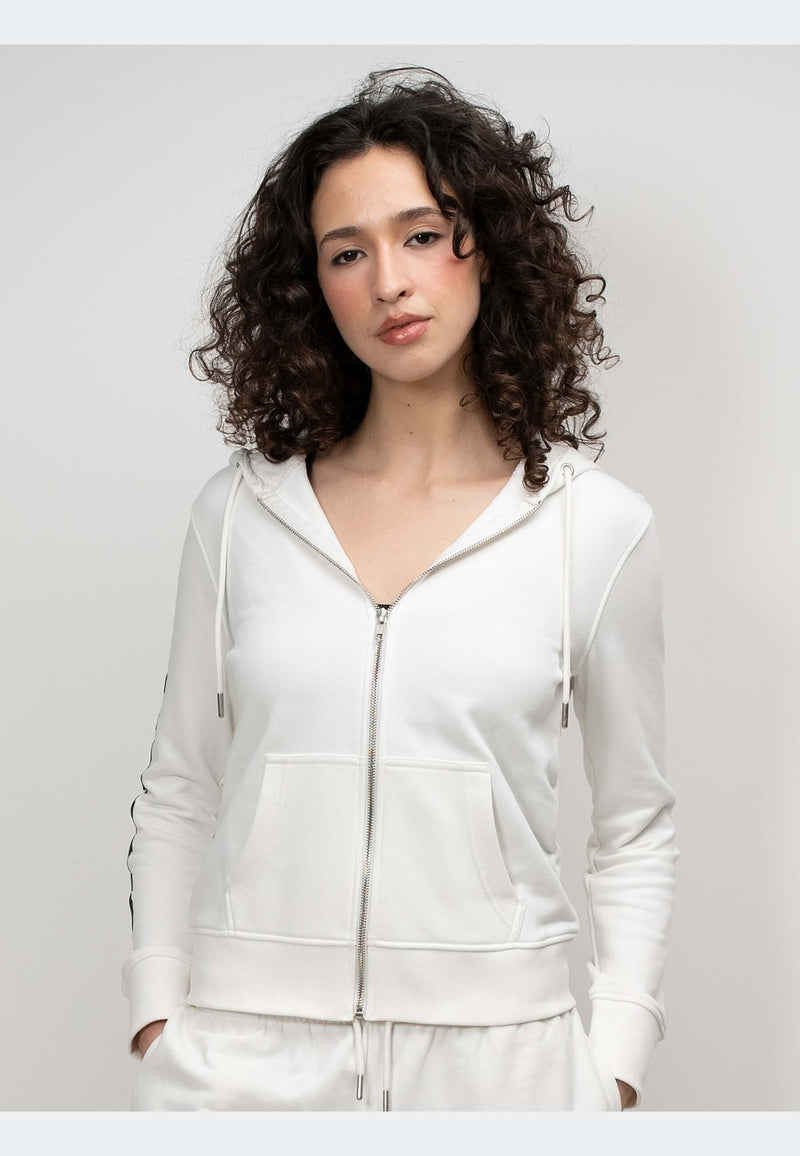 A model wearing an off white hoodie with a zip-through design, showcasing relaxed comfort and premium detailing.