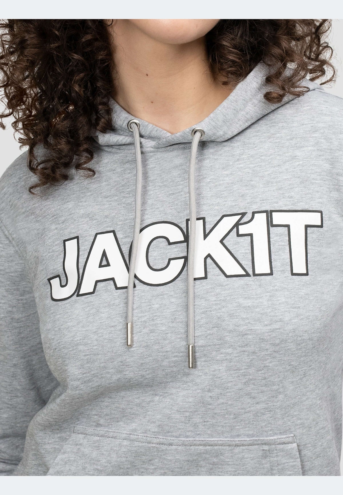 Close-up of a woman wearing a grey hoodie featuring the logo JACK1T, showcasing the relaxed fit and comfortable design.