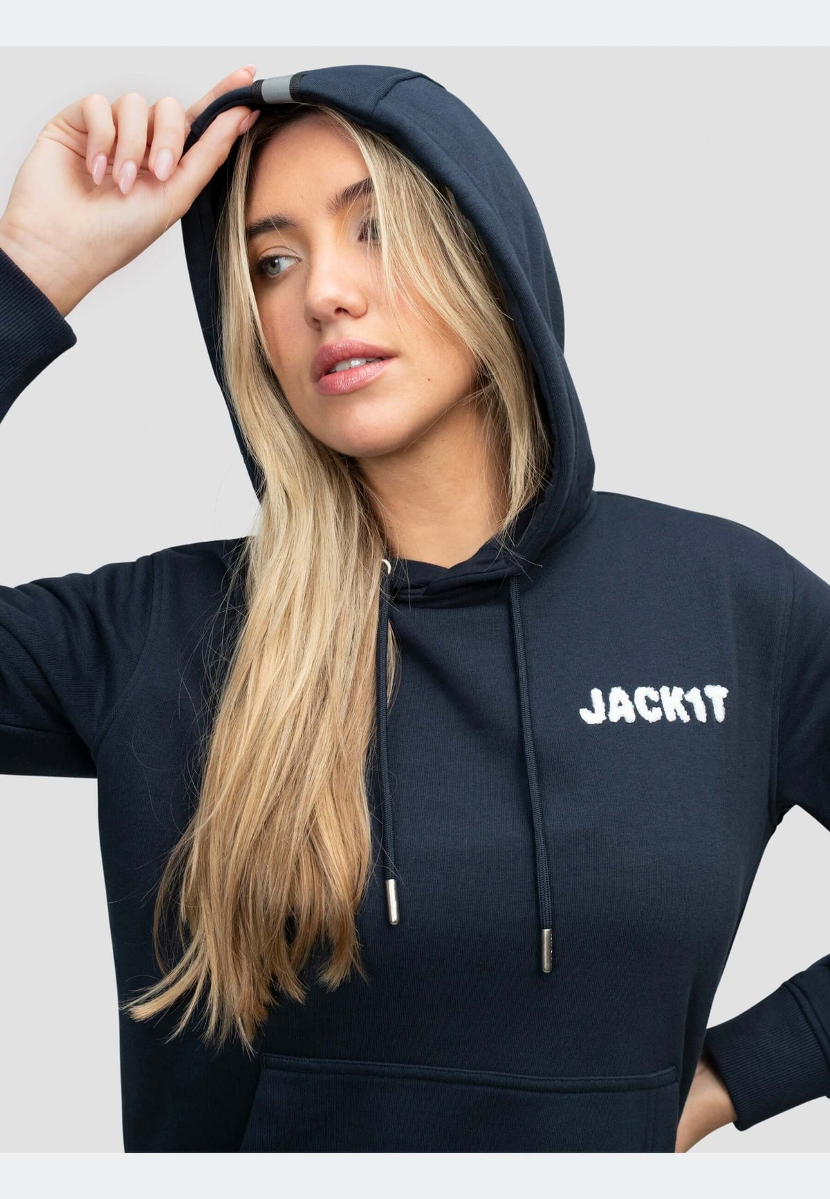 Model wearing a navy hoodie featuring 'JACKIT' branding and a classic hooded silhouette.
