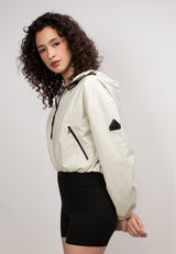 Model wearing a Women's Cream Cropped Jacket with black shorts, showcasing its lightweight and relaxed fit.