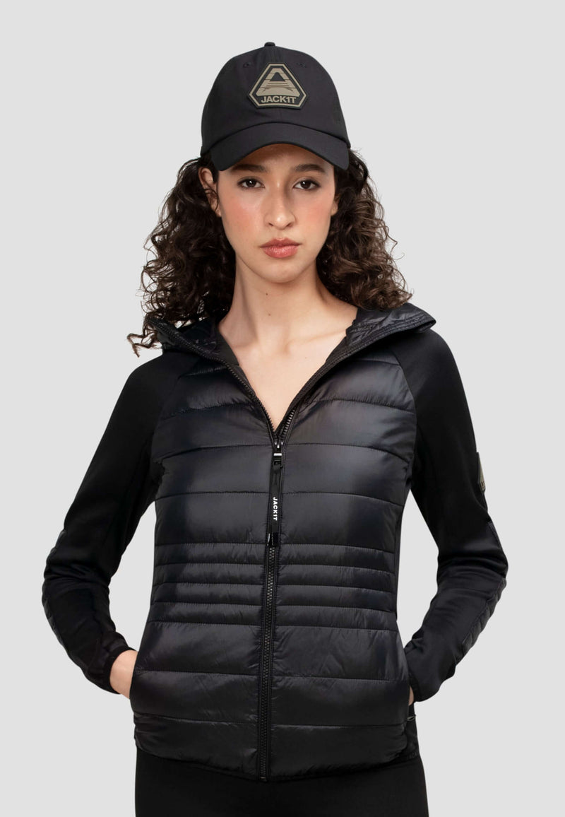 Model wearing a women's black hooded jacket, showcasing its lightweight design and water-resistant features.