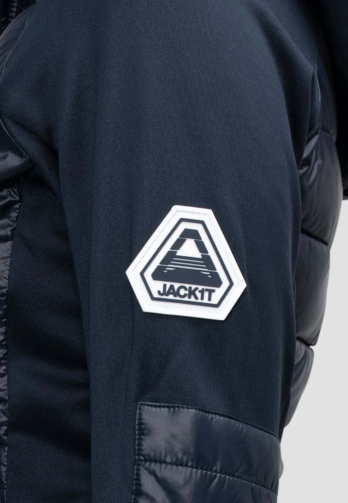 Close-up of the logo on the sleeve of a women's navy hooded jacket, showcasing the JACKIT branding.