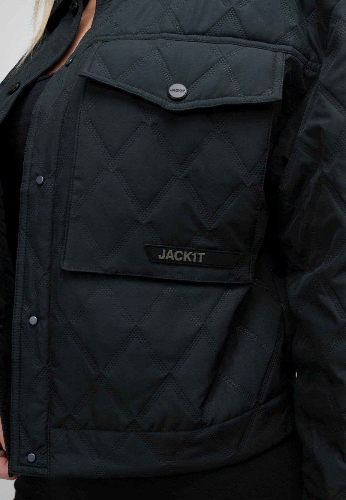women's black quilted shirt jacket close-up showing pocket detail and quilted texture