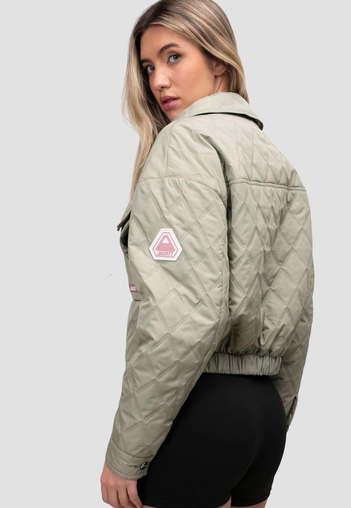 Model wearing a women's sage quilted shirt jacket, showcasing its relaxed fit and lightweight design.