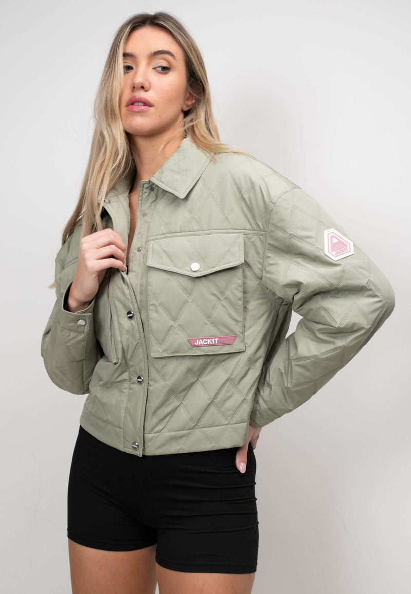 Model wearing a women's sage quilted shirt jacket, showcasing a lightweight and relaxed fit with a stylish design.