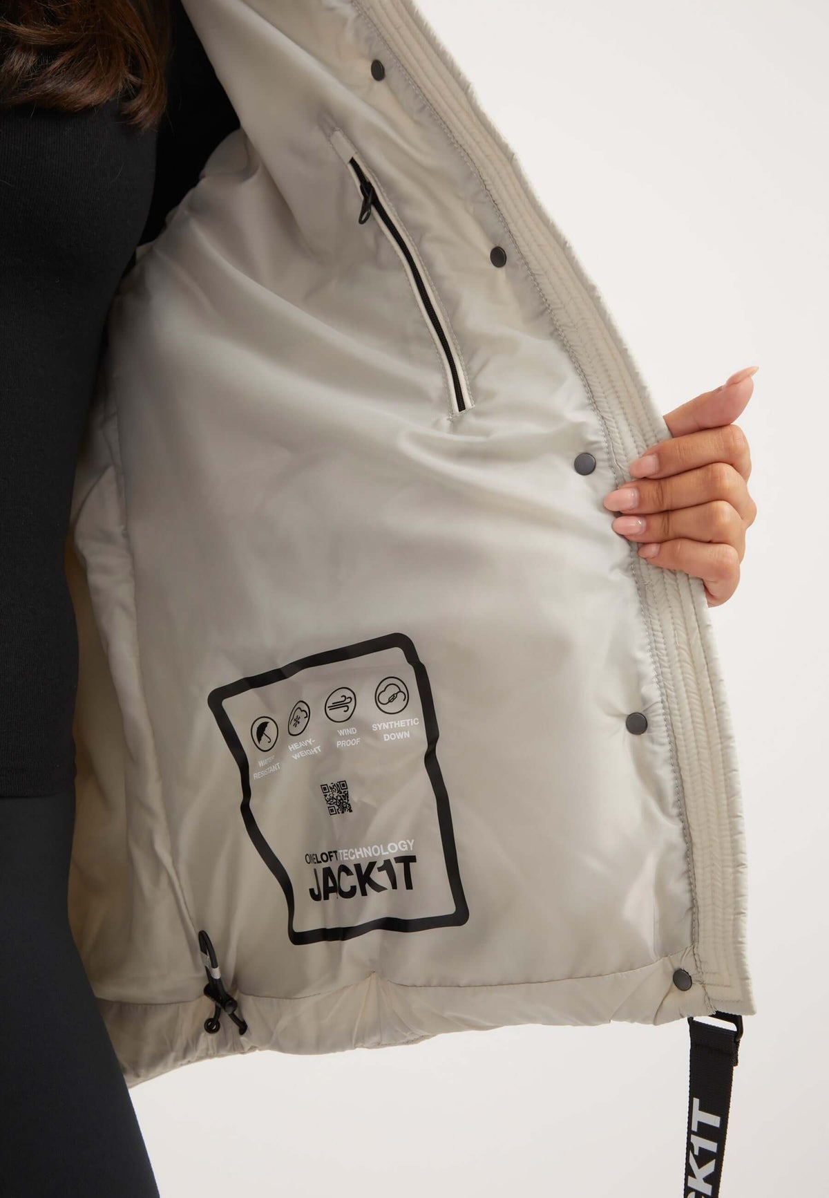 Interior view of the Cloud Prime Jacket Stone, showcasing care label and lightweight design, featuring puffer jacket stone.