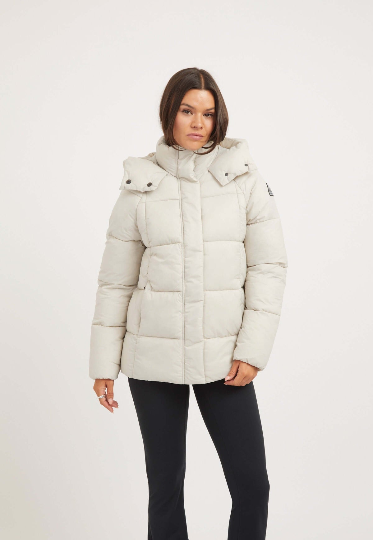 Model wearing Cloud Prime Puffer Jacket Stone with adjustable hood and two-way zips, showcasing lightweight insulation.