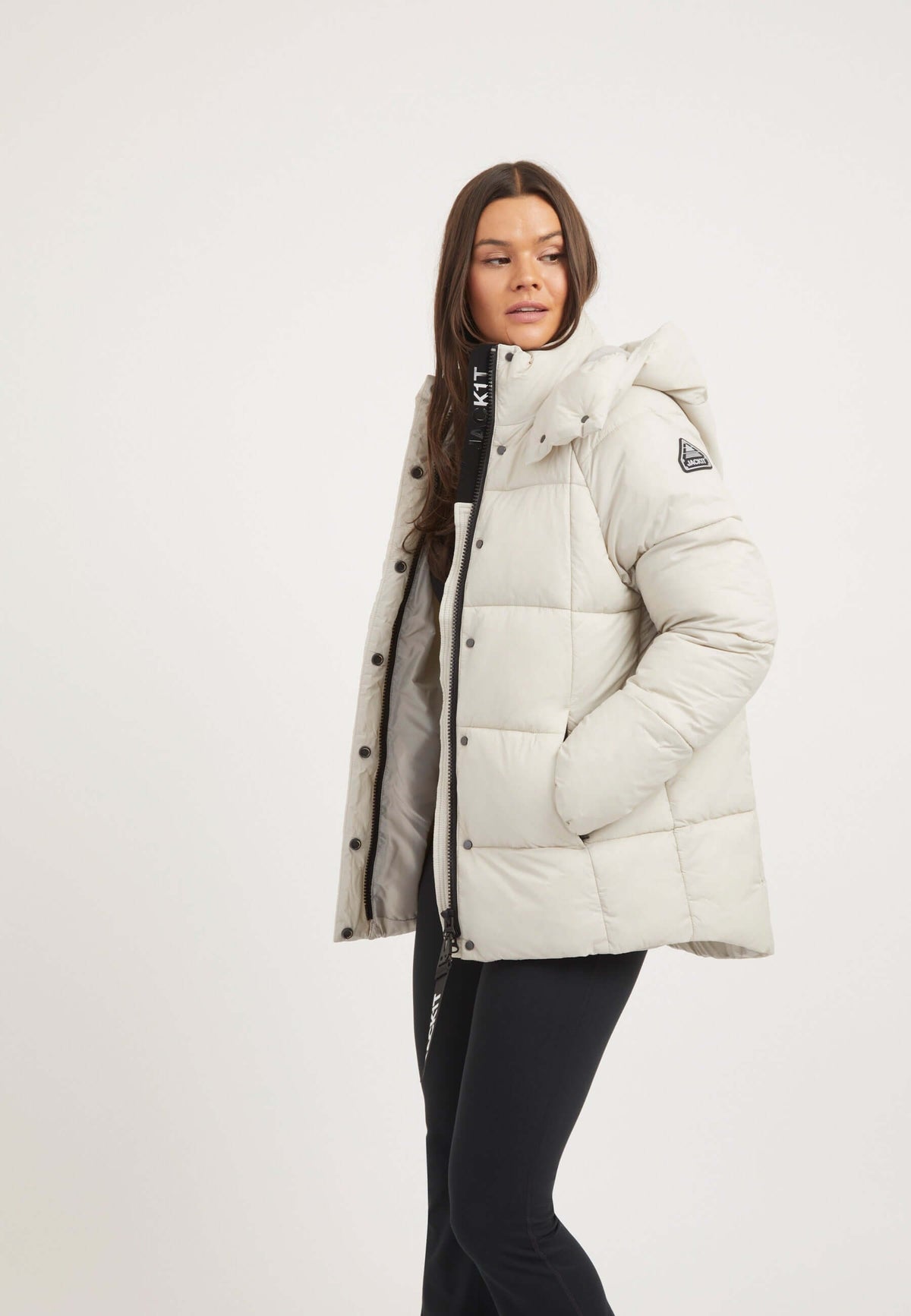 Model wearing Cloud Prime Jacket Stone, a lightweight puffer jacket stone with adjustable hood and premium insulation.