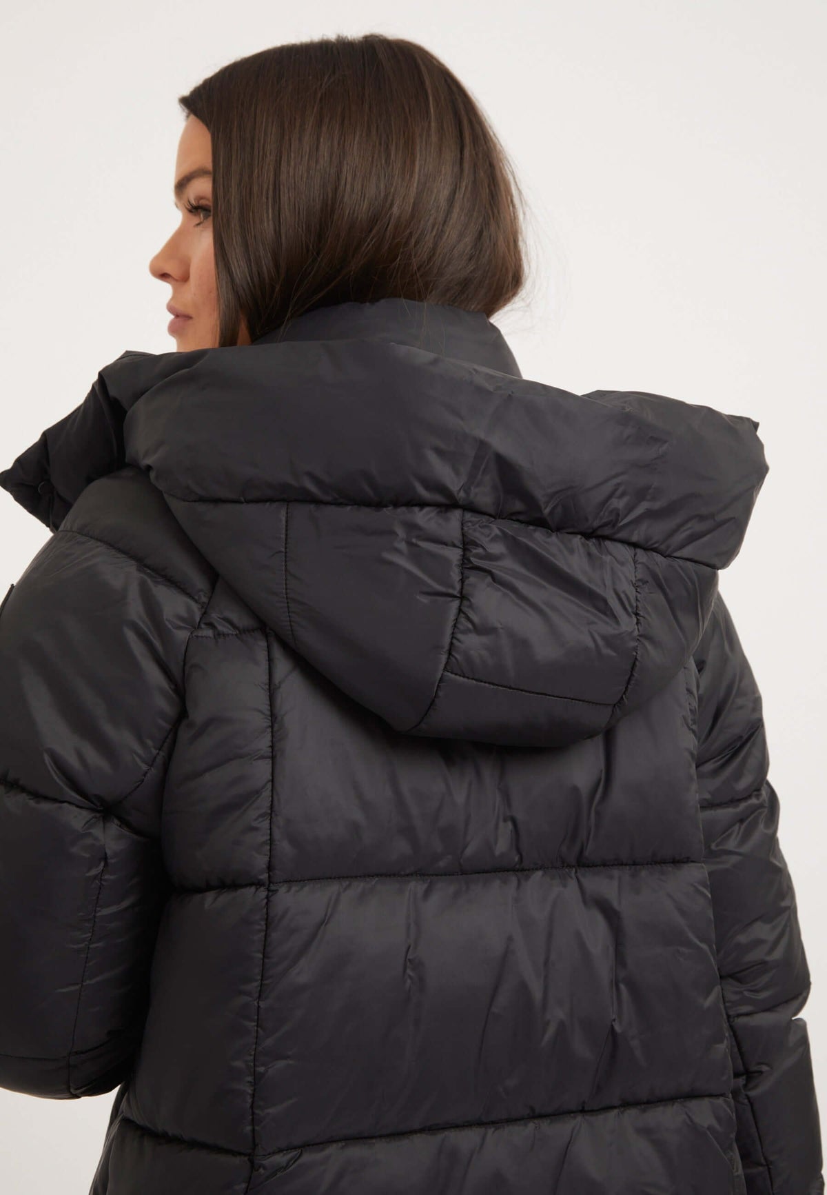 Womens black puffer jacket featuring adjustable hood and tapered design, perfect for winter wear.