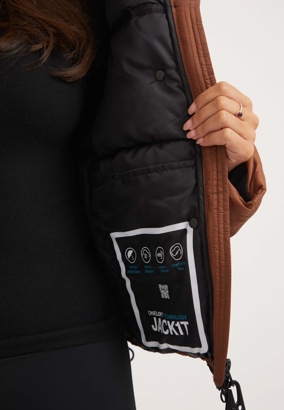 Womens Puffer Jacket Brown, showing the inner lining with care instructions and ONELOFT™ insulation details.