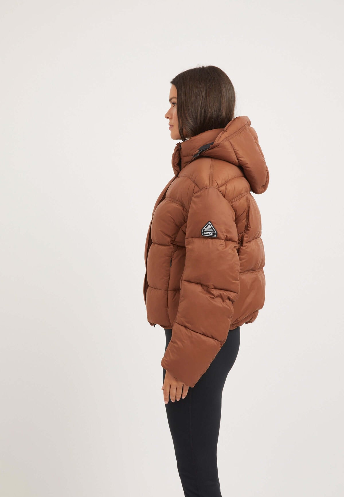 Womens Puffer Jacket Brown displayed on a model showcasing the oversized drop shoulder silhouette and removable hood.