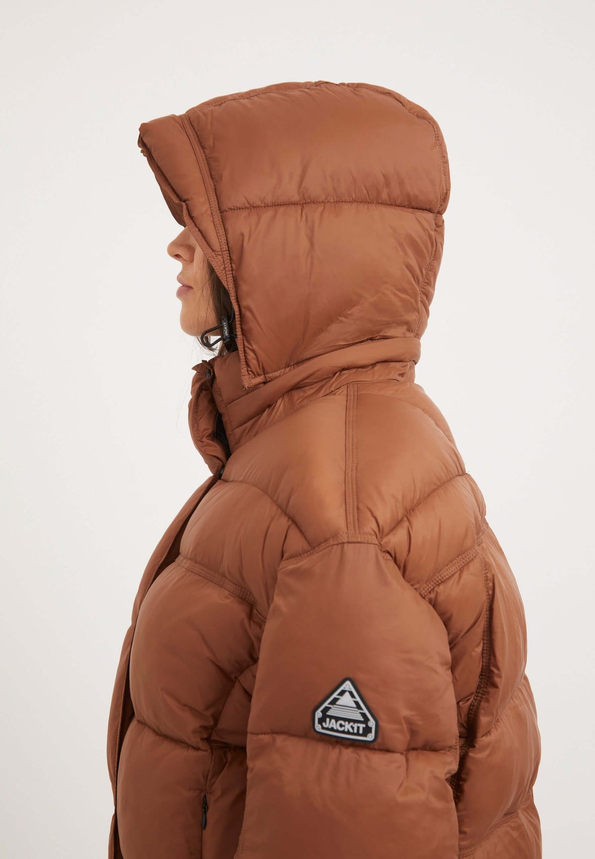 Womens Puffer Jacket Brown featuring oversized drop shoulder silhouette and removable hood, shown in mocha brown.